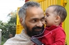 Apra is giving her father a kiss on the cheek