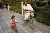 Swami Balendu riding the bike with his daughter Apra